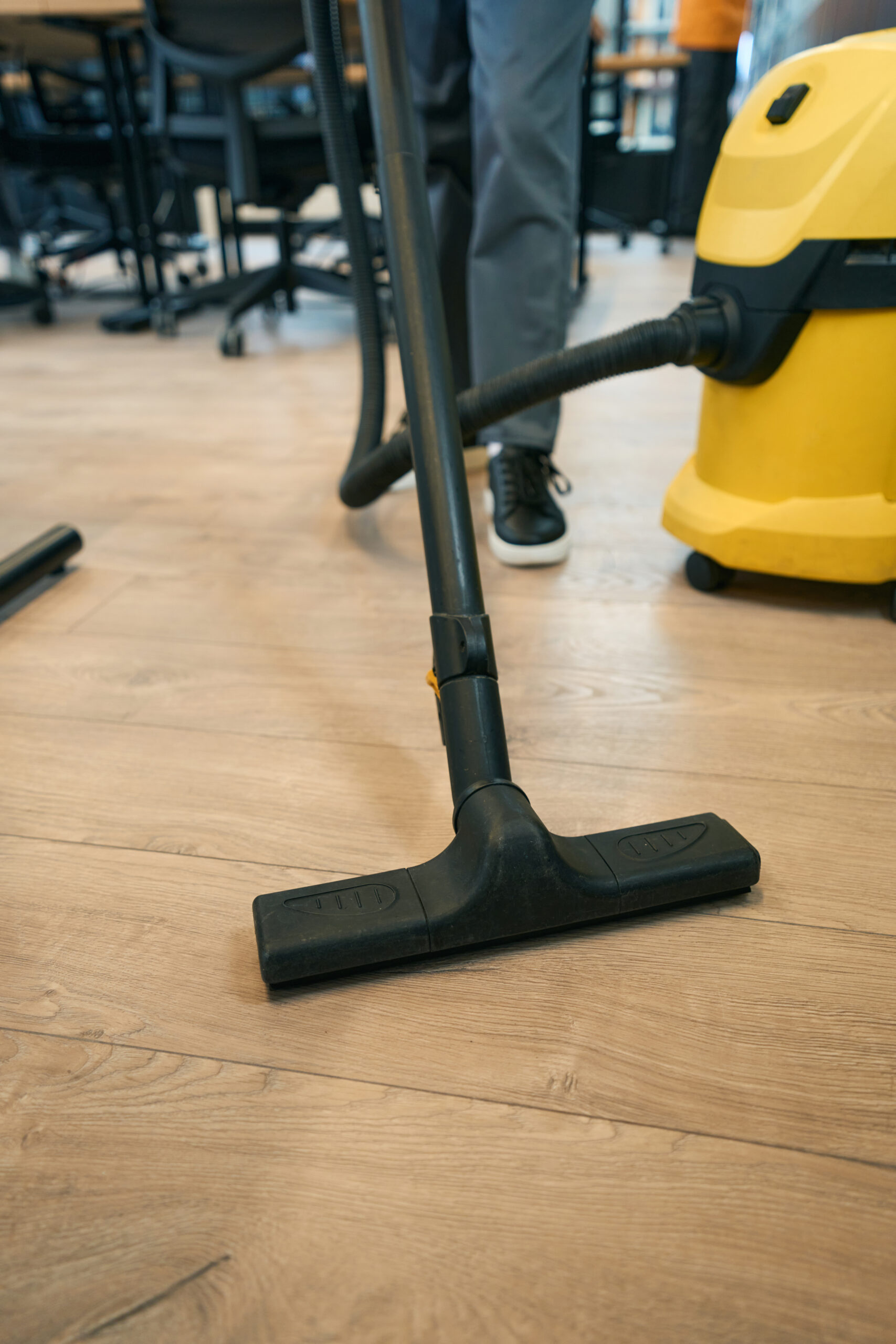 Cleaning a coworking space with a vacuum cleaner